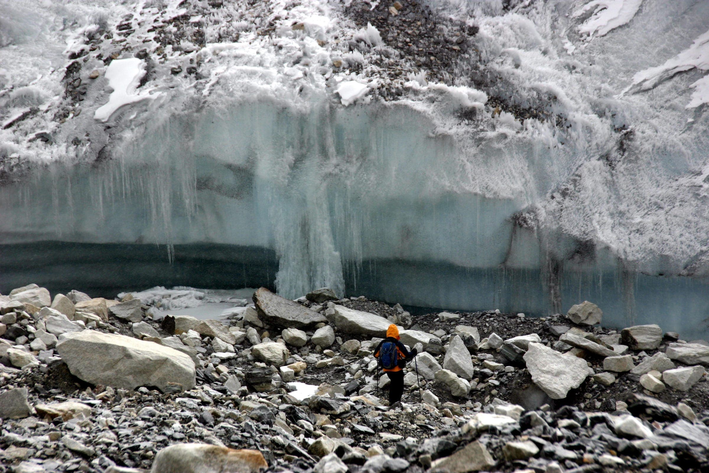 A trekker below the ice cliffs at the edge of the Khumbu Glacier